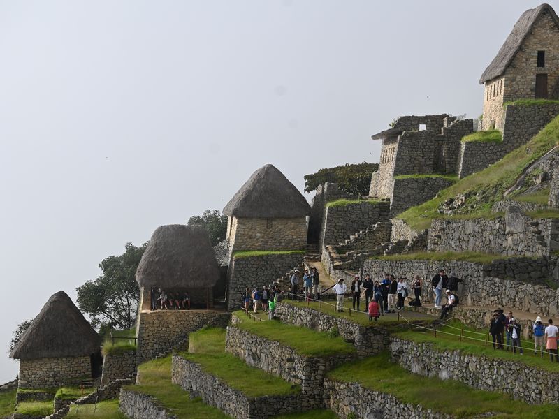 Auf den Terrassen der alten Stadt laufen die Touristen, im Hintergrund restaurierte Häuser.